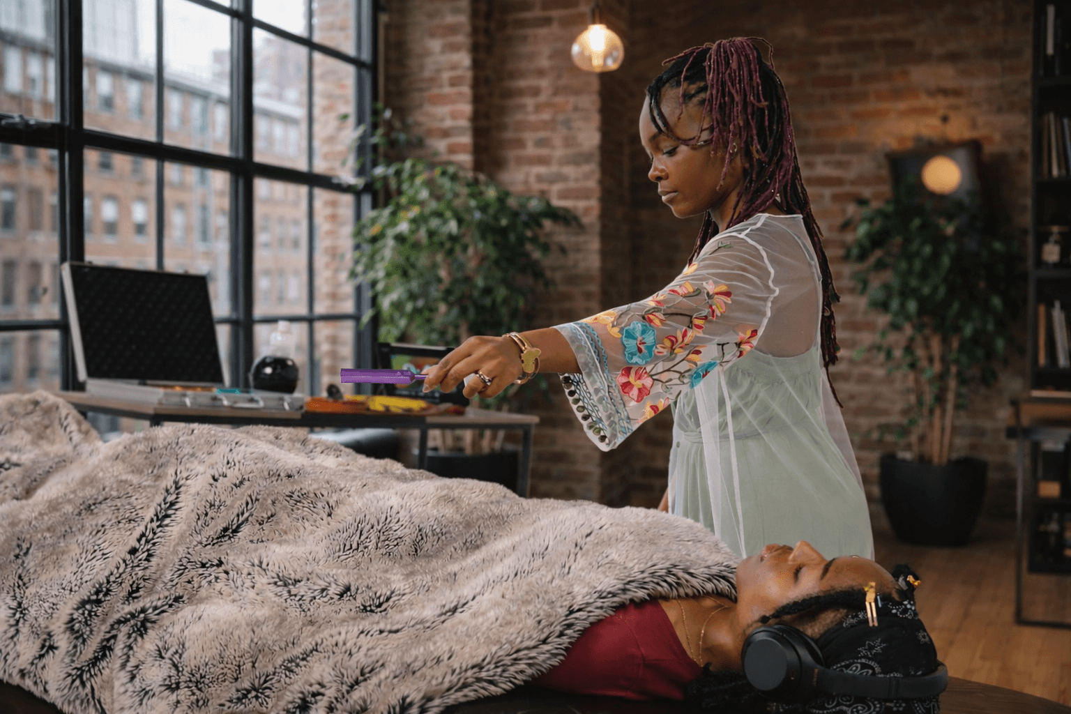 Hannah performing a tuning fork healing session